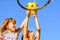 Two little seven year old girls playing basketball outdoors