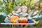 Two little sibling boys making jack-o-lantern for halloween in a