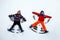 Two little siblings kid boys in colorful winter clothes making snow angel, laying down on snow. Active outdoors leisure