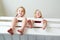 Two little sisters fooling around, playing and having fun in twin bunk bed