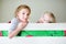 Two little sisters fooling around, playing and having fun in twin bunk bed