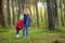 Two little sisters hiking in a forest