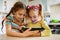 Two little sisters play on a Tablet PC