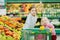 Two little sisters shopping in a food store