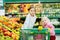 Two little sisters shopping in a food store