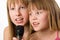 Two little sisters singing in microphone