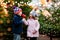 Two little smiling kids, preschool boy and girl eat sweet sugared apple on German Christmas market. Happy siblings