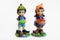Two little statuette - boy and girl in garden with vegetables in hand - toys figurine - white background