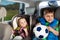 Two little travelers sitting in child safety seats