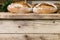 Two loaves of well-baked, cracked bread lie on the wooden counter. Traditional bakery.