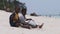 Two Local African Boys Sit on Beach and Play Improvised Bottle Drums, Zanzibar