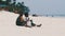 Two Local African Boys Sit on Beach and Play Improvised Bottle Drums, Zanzibar