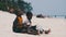 Two Local African Boys Sit on Beach and Play Improvised Bottle Drums, Zanzibar