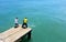 Two local men helping each other to pull the net fishing from the sea