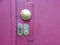 Two Lock Keyholes on Purple Metal Door