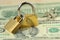 Two locked padlocks on dollar banknotes - Concept of financial security