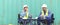 Two logistic staff workers talk and rest sitting in the shipping yard container during break time. Cargo ship import export