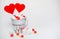 Two Lollipops heart shaped in Small bucket with sweets on white