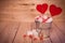 Two Lollipops heart shaped in Small bucket with sweets on wooden