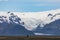 Two lonely bike riders on the main road, large glacier tongue of