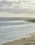 Two lonely unrecognizable fisherman on an empty stretch of Indian ocean beach