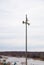 Two loudspeakers-megaphones on a high pole against the background of the river.