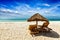 Two lounge chairs under tent on beach