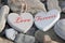 Two love hearts on a rocky beach as one