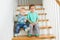 Two lovely brothers sitting on wooden stairs