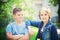 Two Lovely Children Outdoor. Young Boy Looks at Girl