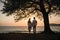 Two lovers find solace beneath a tree at sunset