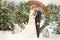 Two lovers, a man and a woman, a wedding in winter. bride and groom love. against the backdrop of decor and trees, snow. holding a