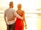 Two lovers people at sunset by the sea romance and tenderness feelings first love date.man and woman blonde in a dress