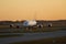 Two Lufthansa airplanes taxiing at sunrise, Airbus A380 and a small aircraft