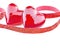 Two luxury red hearts with ribbon on white background. Happy Valentines day. Glitter love confetti.