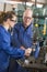 Two machinists working on machine