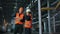 Two maintenance engineers man, woman inspect. Work heavy industry manufacturing