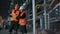 Two maintenance engineers man, woman inspect. Work heavy industry manufacturing