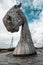 Two majestic horse statues standing tall against a cloudy sky in Kelpher.