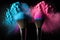 Two makeup brushes with blue and pink exploding powder on black background