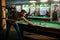 Two male billiard players spend time in poolroom