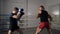 Two male boxers fighting on boxing ring in fight club. Fighters training boxing exercise on fight ring in gym. Male