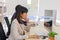 Two male businessmen and business women sit diligently in the office