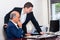 Two male businessmen in their office during working hours