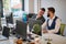 Two male colleagues gossip at work in open space office