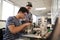 Two Male College Students Building Machine In Science Robotics Or Engineering Class