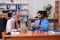 Two male employees playing cards at workplace