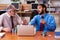 Two male employees playing cards at workplace