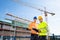 Two Male Engineers Supervising The Construction Site