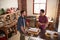 Two male friends hanging out in kitchen, high angle view